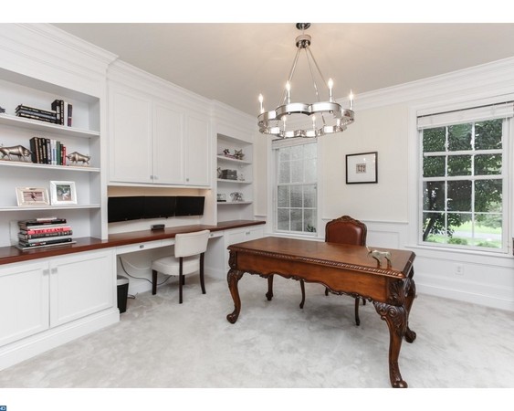 First floor office with French doors, crown molding and custom built in bookcases